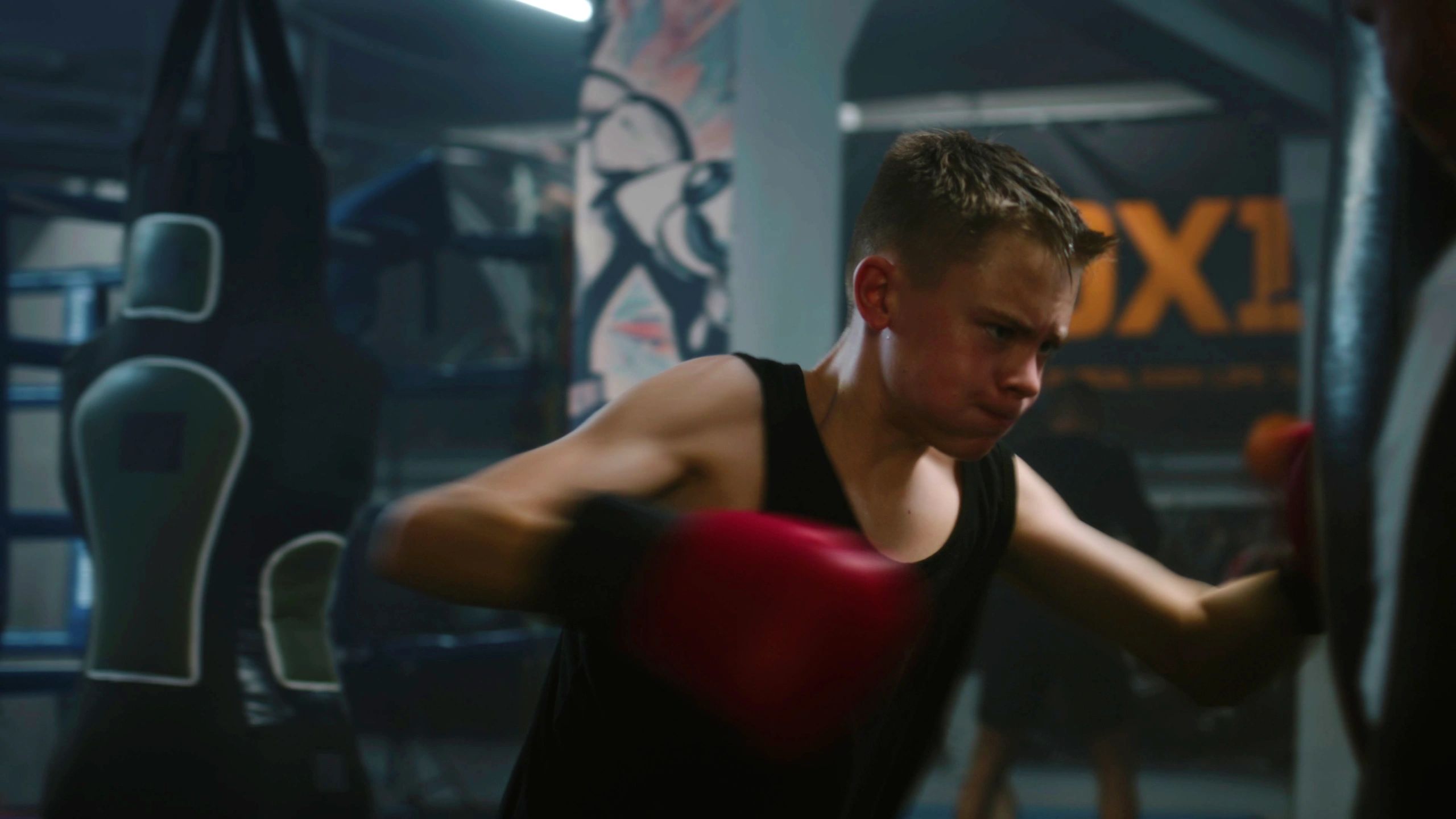 Young athlete training power and focus in a gym session