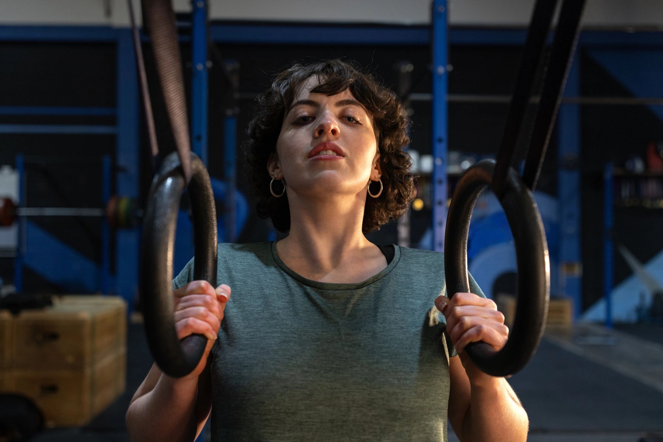 Athlete training on gym rings to improve strength and control
