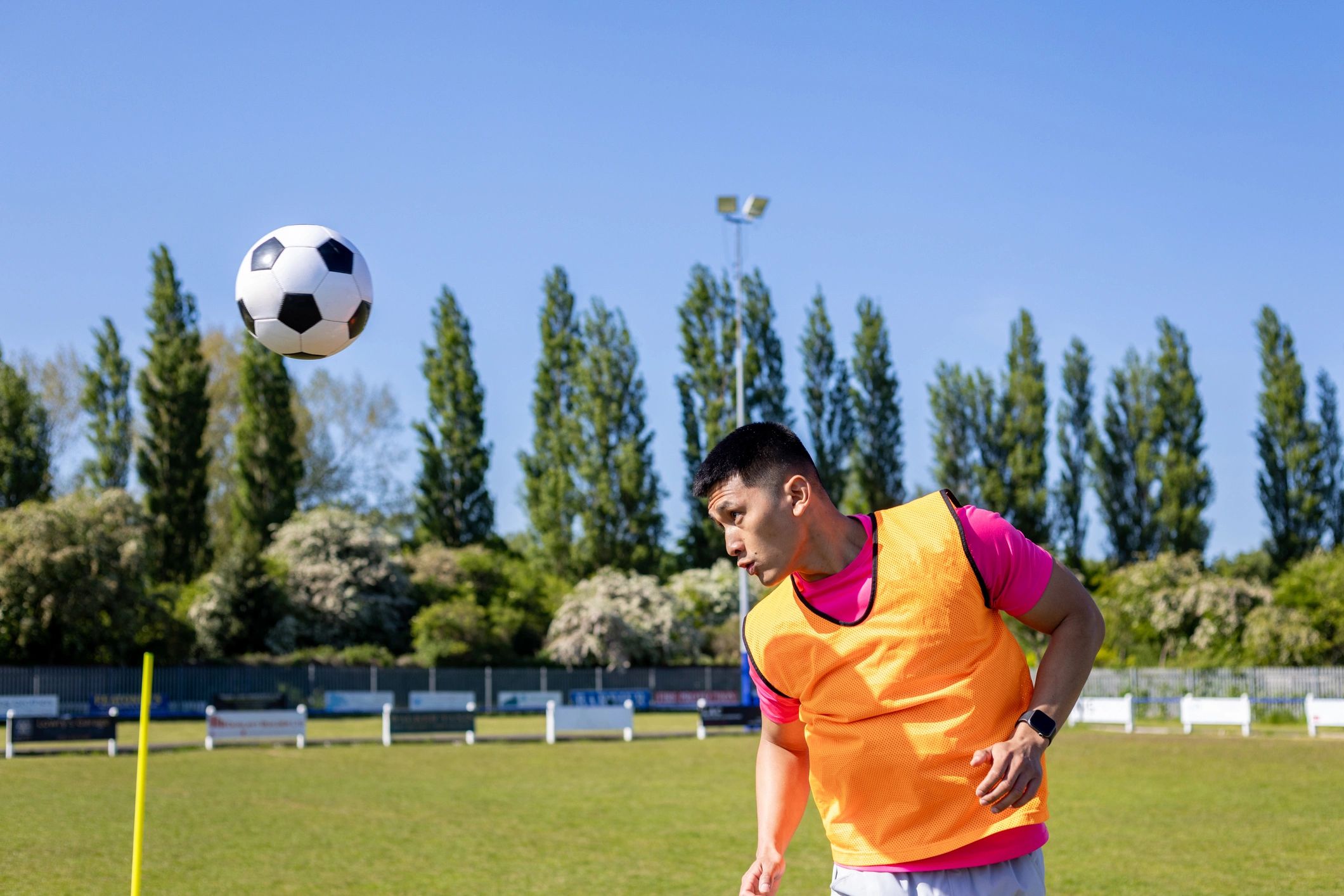 Footballer heading the ball during training