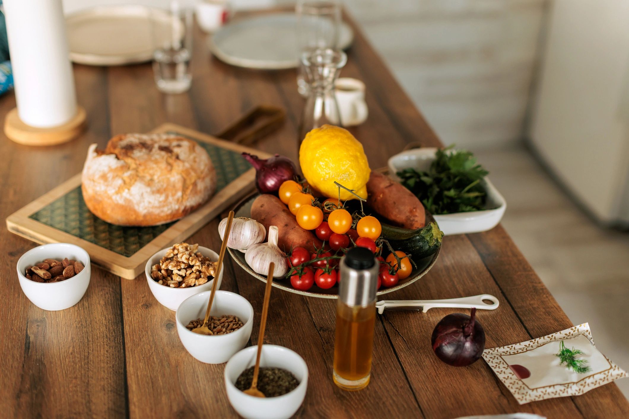 Fresh vegetables, nuts and whole foods on a rustic table