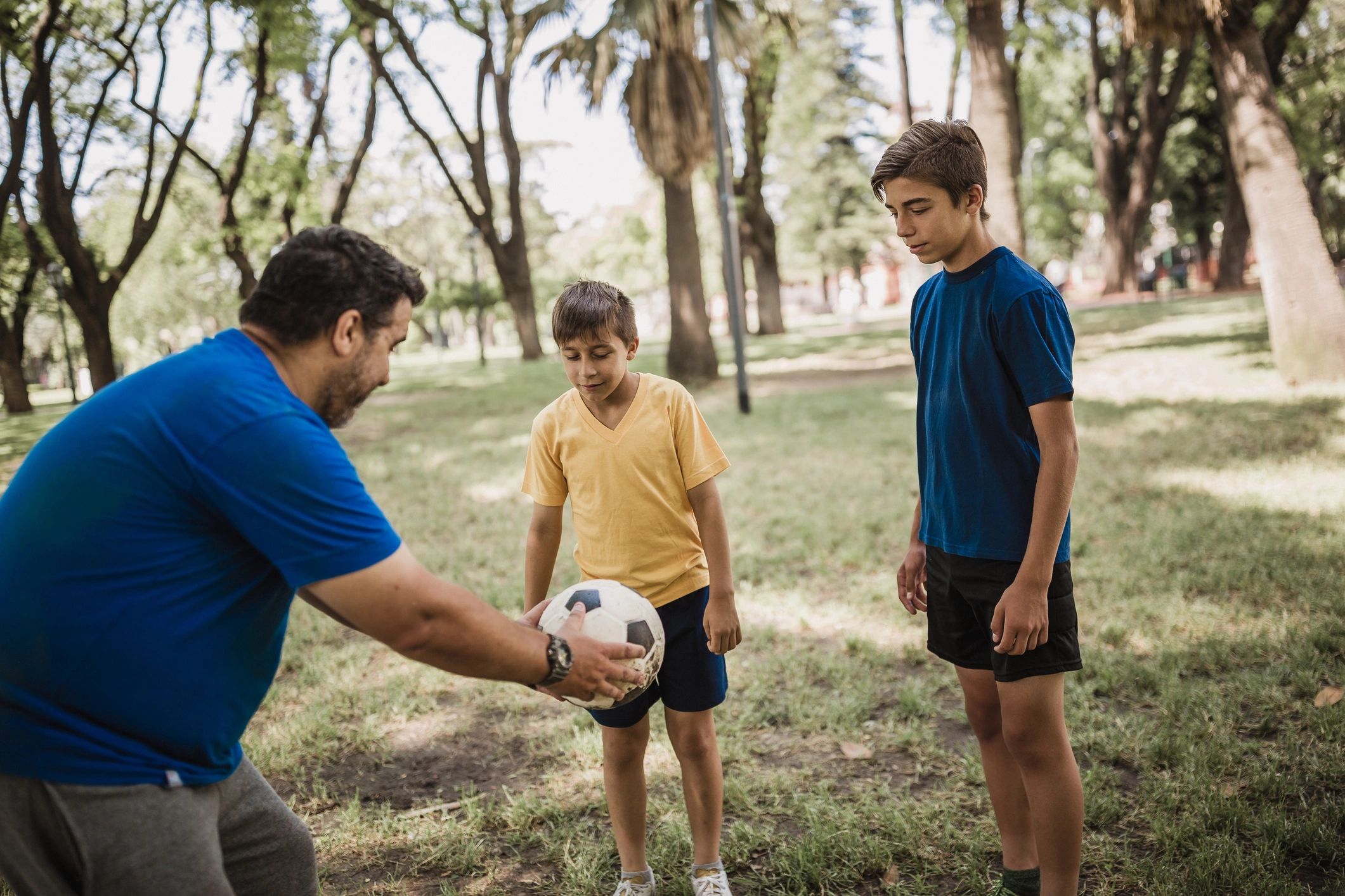 Young players learning football skills in the park